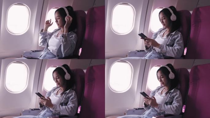 目前，乘坐飞机旅行的亚洲女性正愉快地戴着耳机听音乐，轻声哼唱。能唤起快乐和放松。
