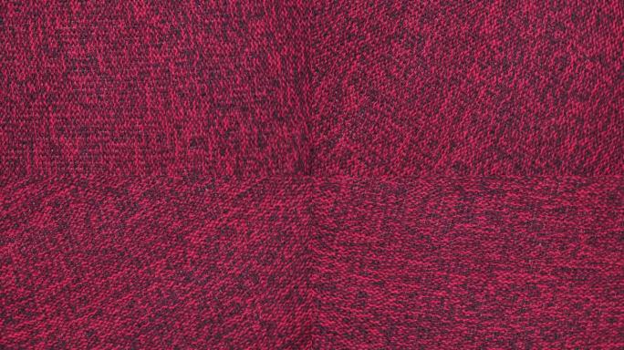 柔软的针织羊毛详细的纹理。天然织物近距离针织图案。品红针织品，温暖的羊绒表面。旋转,宏。舒适的奶油纺