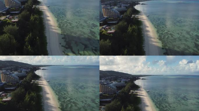 北马里亚纳群岛塞班岛白色沙滩海岸线的无人机倾斜拍摄