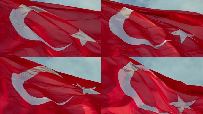 在阳光明媚的日子里，红色土耳其国旗在天空中摇摆的低角度特写镜头