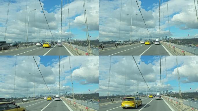 手持拍摄的汽车在博斯普鲁斯桥上移动对多云的天空在白天在伊斯坦布尔，土耳其