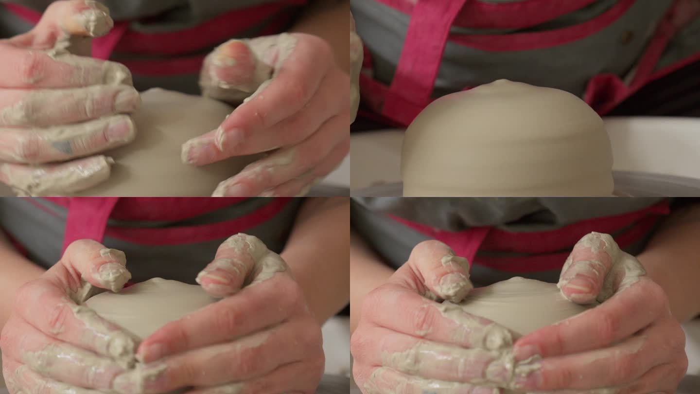陶艺师小心翼翼地用双手将一块粘土放在抛轮上
