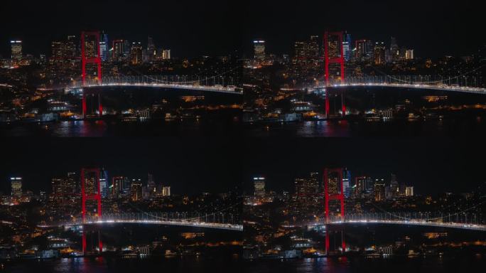 夜晚的伊斯坦布尔。平稳的交通行驶在法提赫苏丹穆罕默德桥与背景城市景观在晚上。