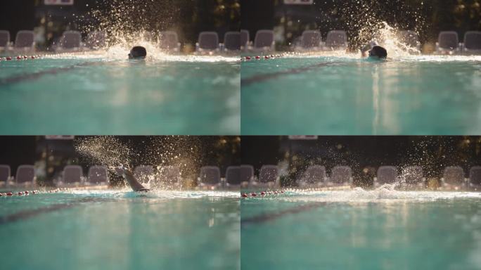 SLO - MO熟练男子游泳运动员在阳光下示范自由泳技术