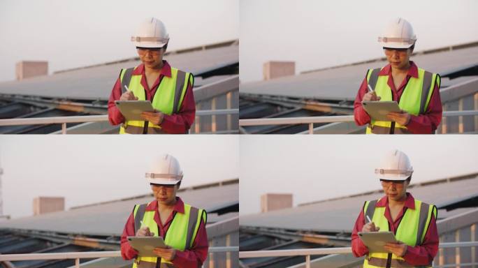 一名戴安全帽的妇女在太阳能发电站检查电力供应