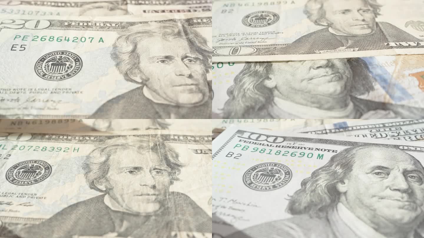 把不同面额的美元钞票扔在桌子上，特写肖像。