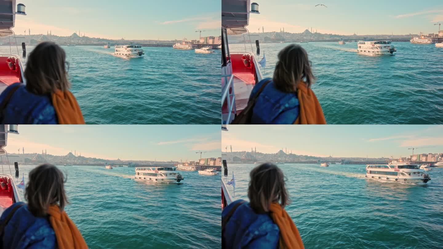 女游客在博斯普鲁斯海峡美丽的游船上享受着清爽的微风