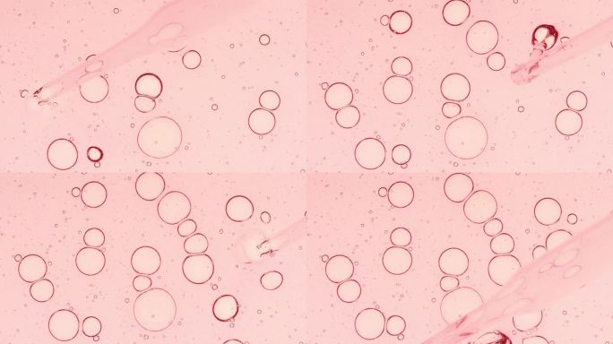 透明的粉红色液体油，血清，凝胶从移液器到培养皿。化学实验室研究。天然有机化妆品，医药。生产天然化妆品
