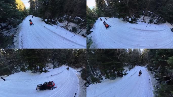 一群雪地摩托在冬天的森林里行驶。