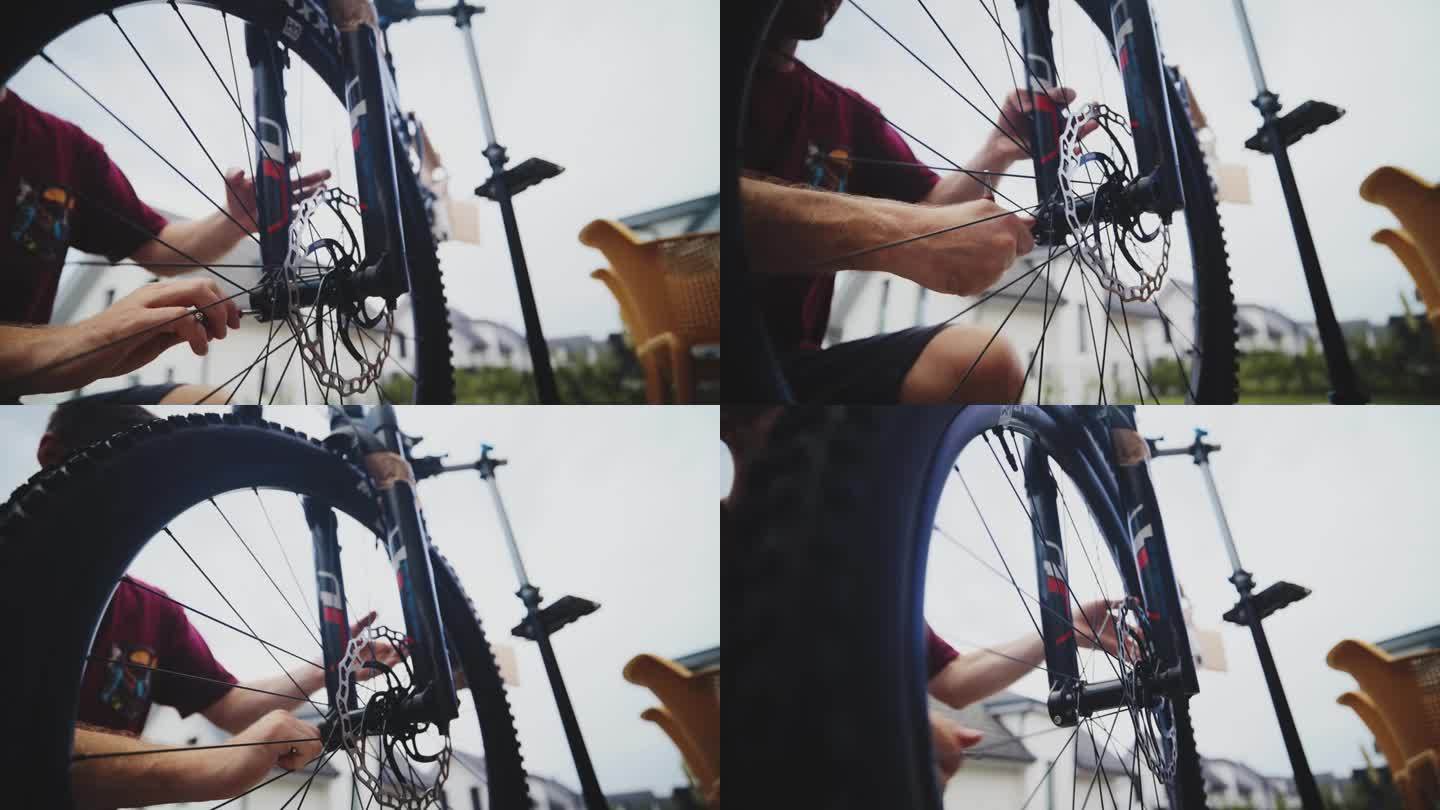 男子在院子里收紧山地车轮胎的SLO手持镜头。自行车修理。