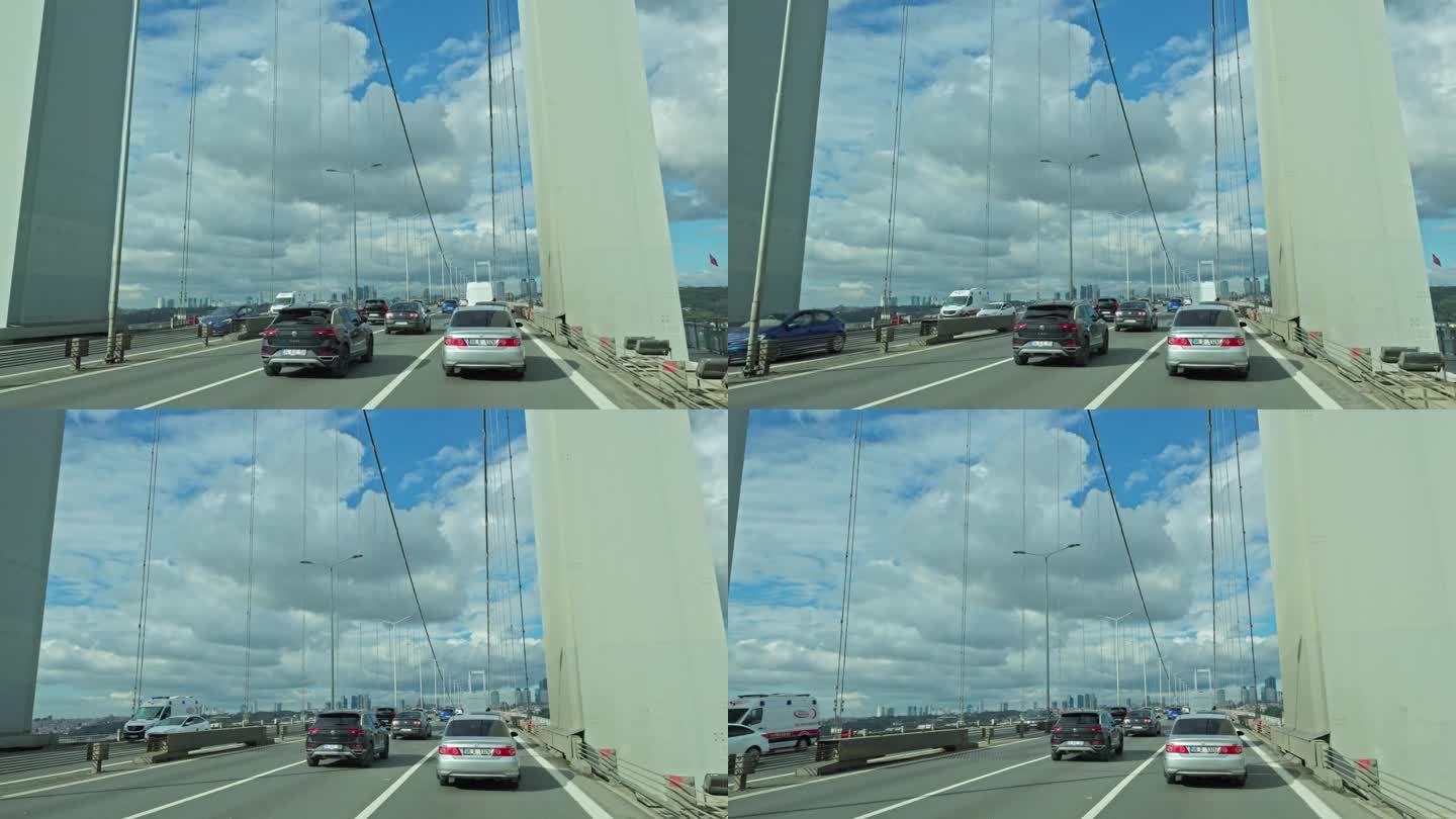 在晴朗的一天，土耳其伊斯坦布尔，汽车在高高的博斯普鲁斯大桥上移动的手持镜头