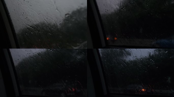 雨水滴落在车窗上缓缓落下