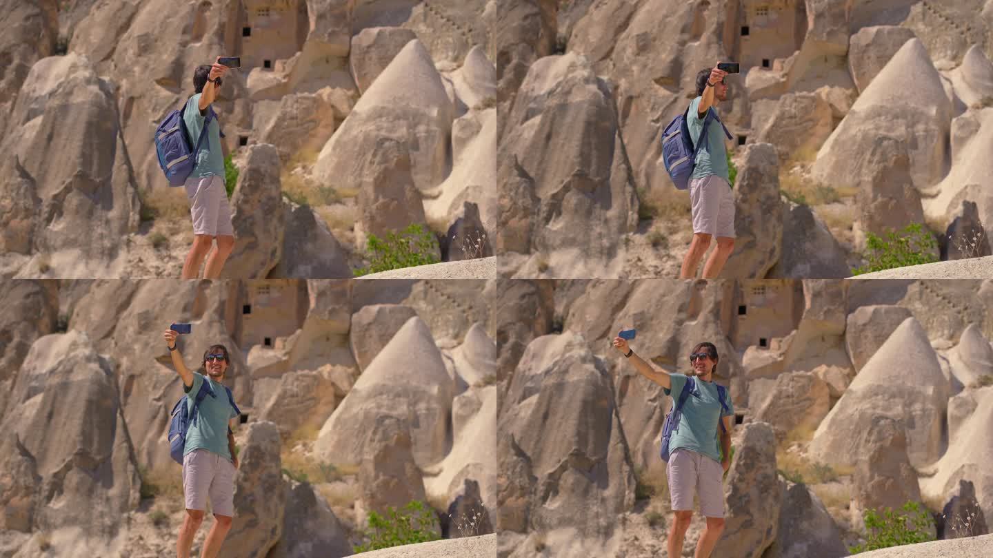 一名年轻的游客探索着讲述土耳其卡帕多西亚古老故事的非凡岩层。这些超现实的岩石，曾经是古代居民雕刻的家