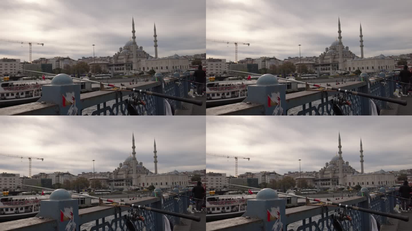 手持拍摄的鱼竿在加拉塔桥与蓝色清真寺的背景在伊斯坦布尔，土耳其