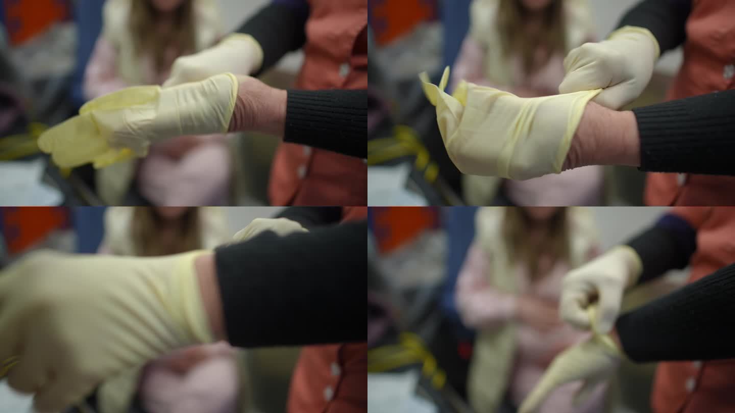 把手收起来。医护人员戴上橡胶无菌手套，为一位年轻孕妇提供必要的医疗护理。