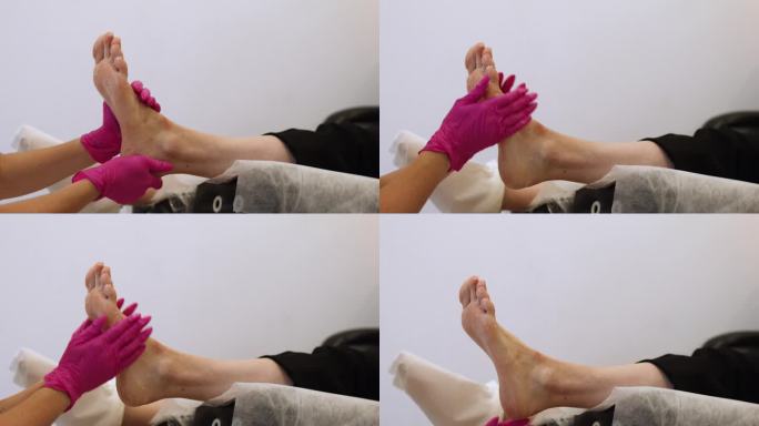 足疗大师在医学面膜按摩脚部。在Spa沙龙接受经典足疗按摩霜程序的女性腿部。腿部和指甲皮肤护理。足疗程