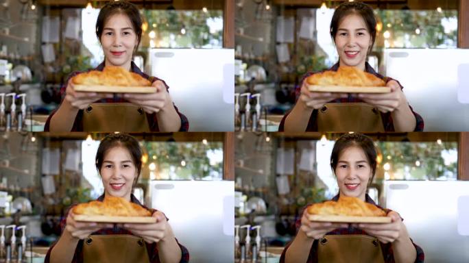 4k，生活方式快乐的面包店老板提供美味的羊角面包盘，亚洲女性站在镜头前，小企业创业聘请有吸引力的模特
