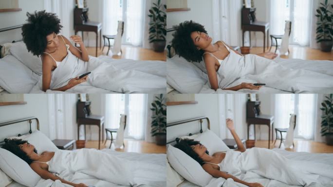 清晨昏昏欲睡的模型掉落枕头。黑头发女人失眠后醒来