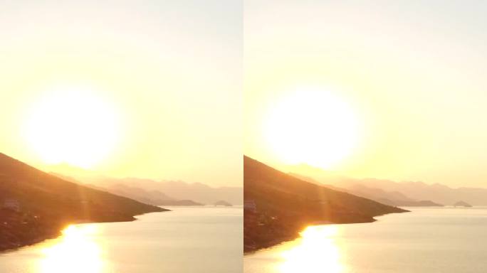 空中无人机拍摄的四鹿湖，朝山上的太阳倾斜拍摄