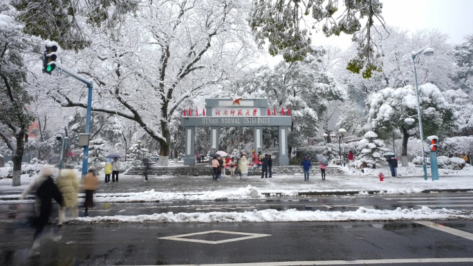 下雪天在湖南师范大学门口打卡的人群