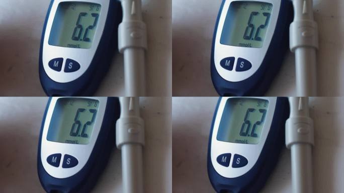 测量血糖的装置，便携式血糖仪。血糖仪屏幕上的血糖读数。糖尿病保健