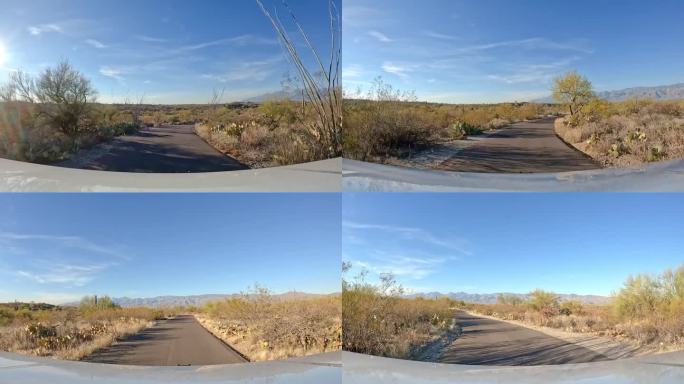 视角——在索诺兰沙漠萨瓜罗国家公园的公园道路上开车;林康山;道路较少的概念，开阔的道路，和沙漠环境