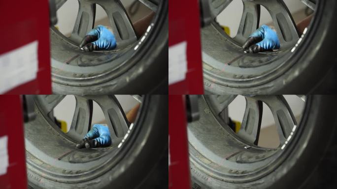 汽车修理工在车库里用车轮平衡器平衡汽车轮胎。精密对中，旋转测试，平衡检查，确保安全驾驶。车辆保养，轮