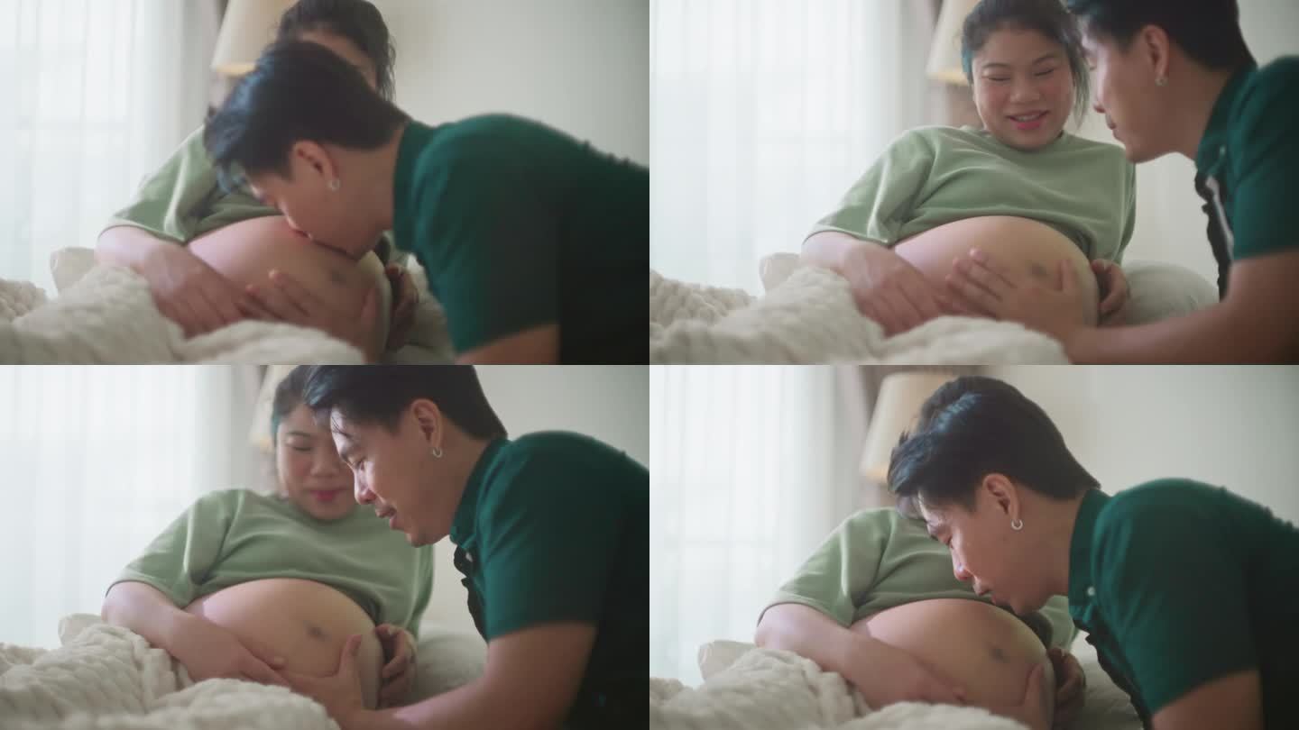 亚洲已婚丈夫对他怀孕的妻子倾注爱意，在她成长的肚子上播种一个充满爱的吻，在家里听着他婴儿般的心跳声