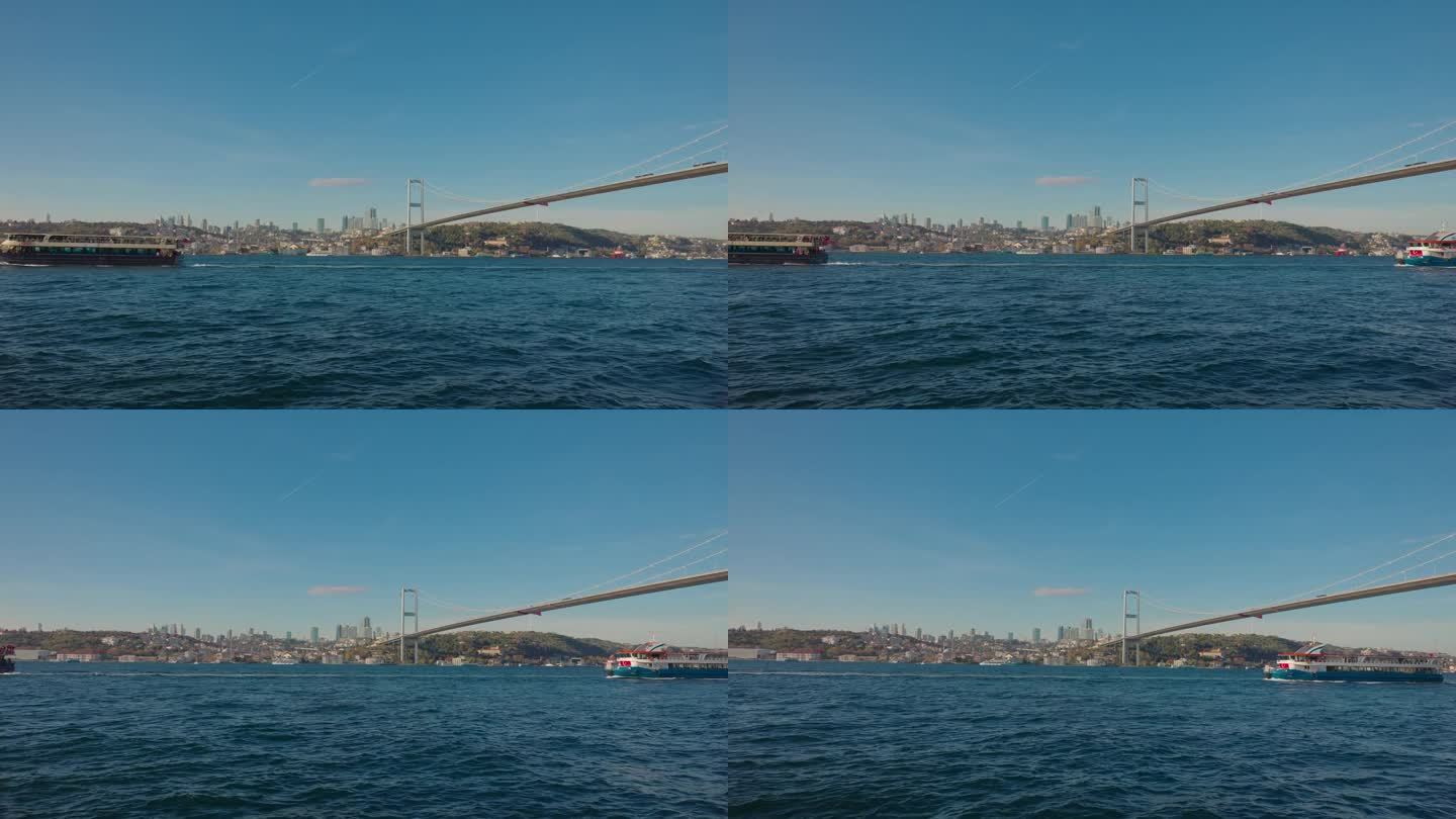 土耳其伊斯坦布尔博斯普鲁斯大桥下的渡轮在海景上移动的封锁镜头