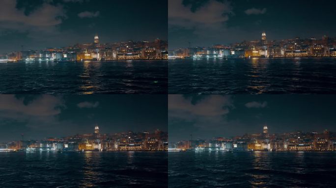 船的视角照亮塔和城市景观的马尔马拉海对天空在伊斯坦布尔，土耳其