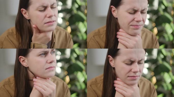 不健康的悲伤的年轻白人妇女的手在喉咙痛感觉不适的特写。颈痛、皱眉、甲状腺紊乱、咽喉痛、扁桃体发炎等概