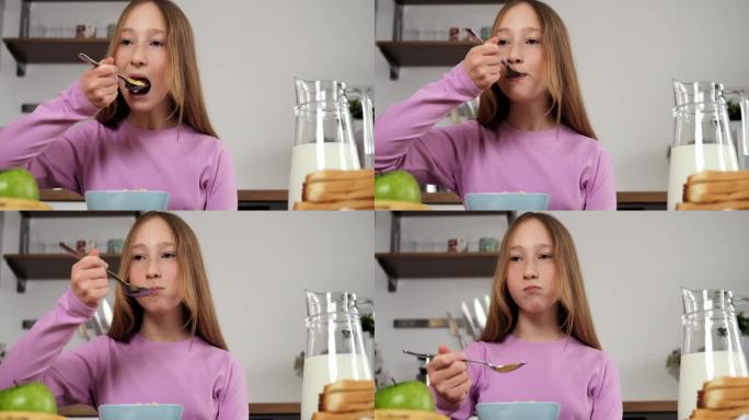 少女坐在厨房享受营养早餐电影特写女孩的一天从关心和健康的膳食开始。精心准备的早餐是孩子早晨快乐的源泉