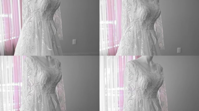 一个疯子穿着白色婚纱的特写镜头。背景中有粉红色的窗帘