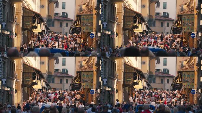 意大利佛罗伦萨，行人和通勤者走在维琪奥桥风景如画的中世纪拱桥区域，那里有各种珠宝店和纪念品商店