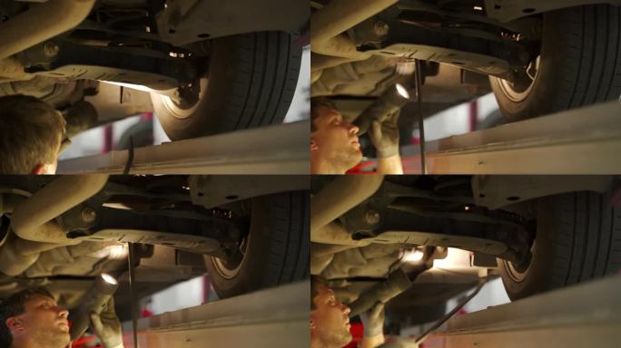 汽车修理工在维修舱内用液压探测仪检查汽车悬架、转向装置。专业检查汽车系统的安全、维修。