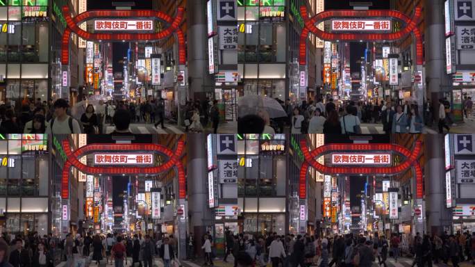 日本东京，新宿，著名的歌舞伎町门前的人群穿过街道