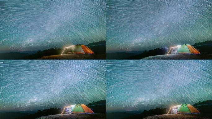 夜景与帐篷露营在山上与流星雨，星星，和宁静的自然