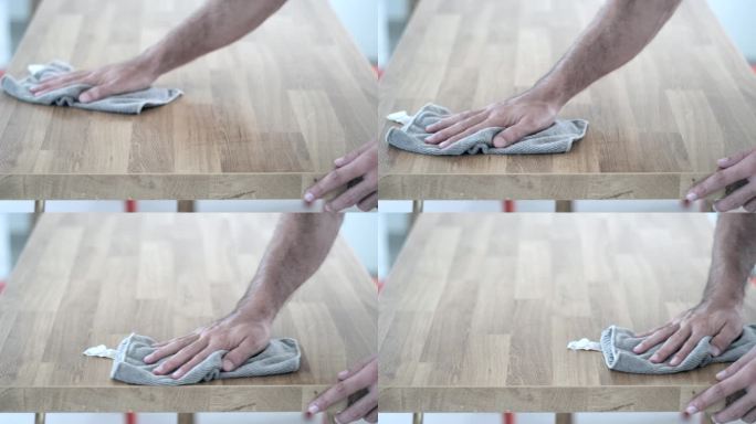 高效清洁:人工用抹布擦拭木桌