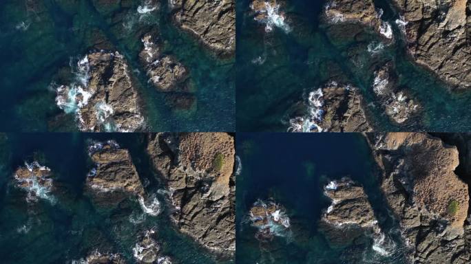 无人机俯瞰海浪冲击小岩石岛屿的画面