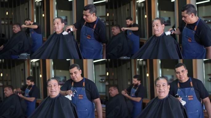 一位理发师在理发店服务后清理老人的画像