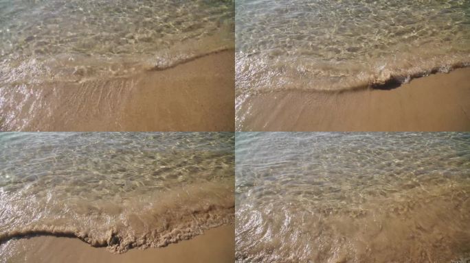 清澈的海水海浪冲刷沙滩海岸。黄沙沙滩和平静的海浪慢动作慢动作。暑假。复制香水广告的空间概念，香味和新