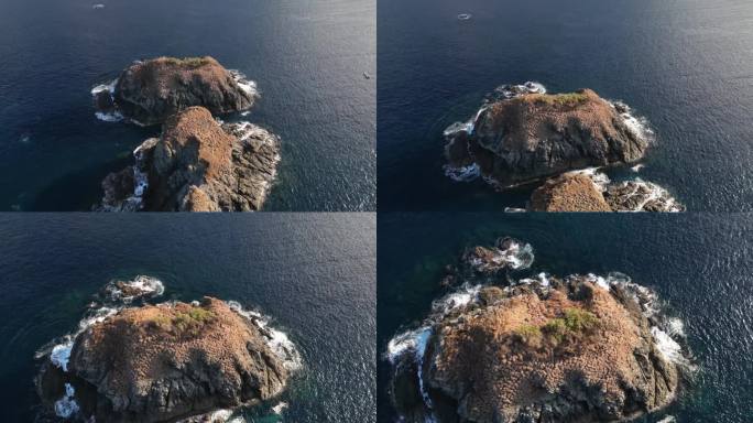 无人机拍摄的小岩石岛屿被海浪碾压