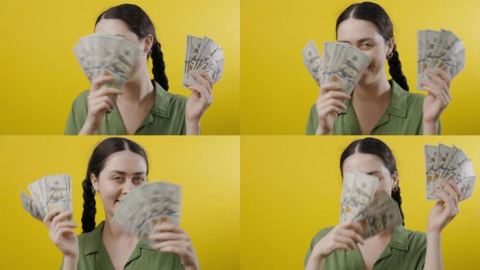 一位年轻女子的肖像，微笑着展示着一美元钞票的扇子。黄色背景。财富和成功的概念