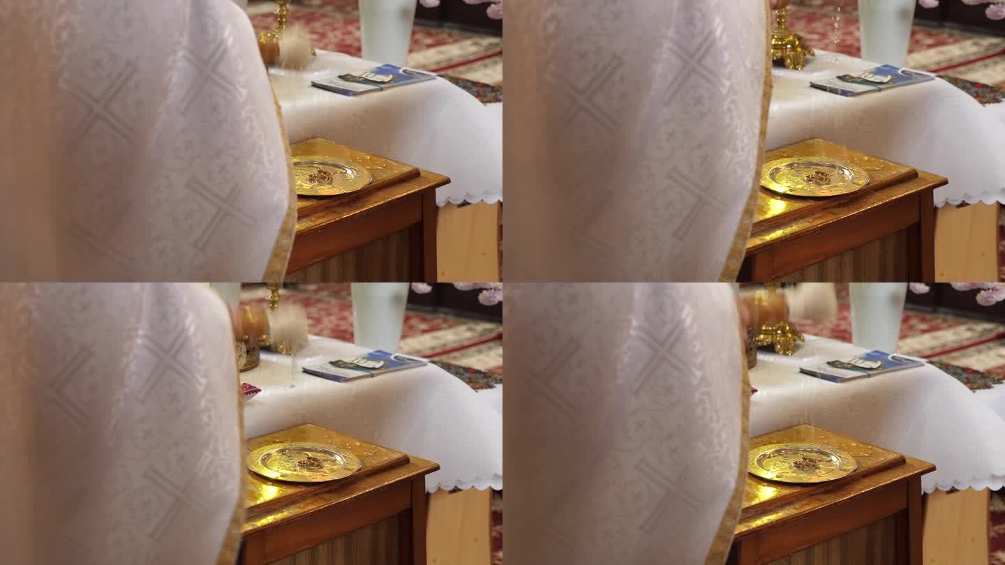在教堂举行婚礼时，牧师将圣水洒在结婚戒指上。教堂婚礼传统。