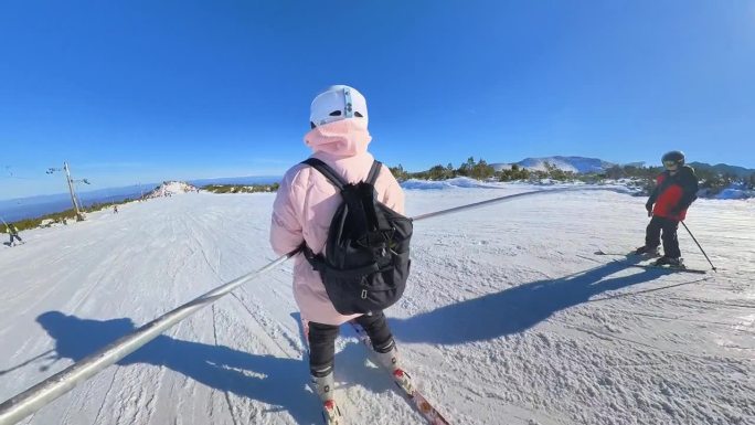 年轻的业余女子滑雪下山。