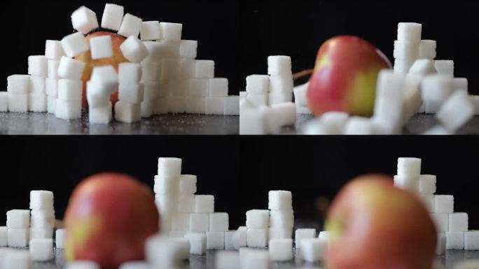 慢动作红苹果冲破白糖方块堆积的墙。选择健康的生活方式。不健康饮食的概念，糖尿病，肥胖，心脏病。甜食上