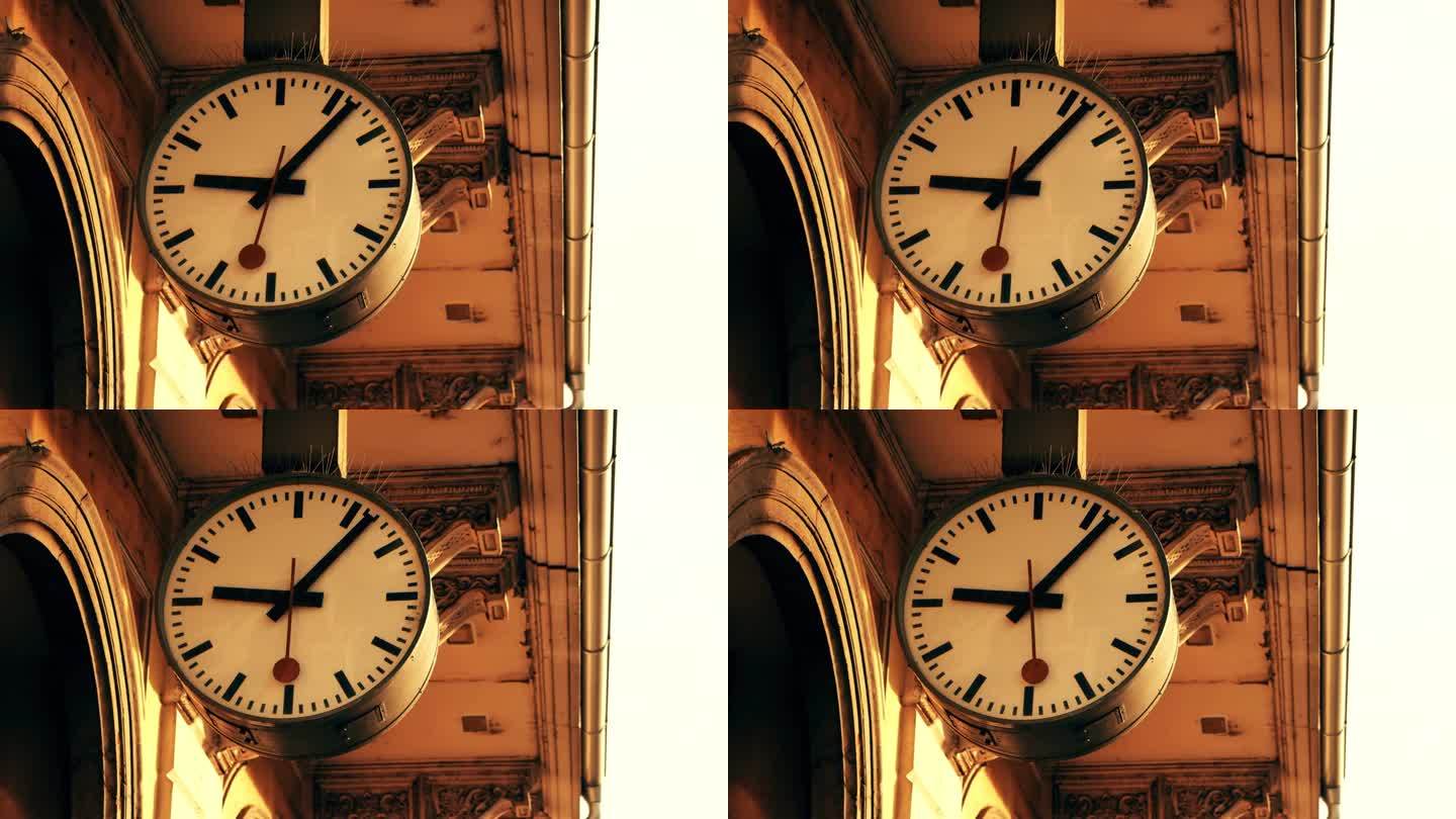 时间机器概念。时钟指针朝相反的方向移动。回到过去。Wayback机器。车站的大钟面。旧建筑上的古色古