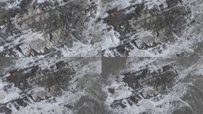 航拍俯瞰威海高区玛珈山娃娃岛礁石冰冻海浪