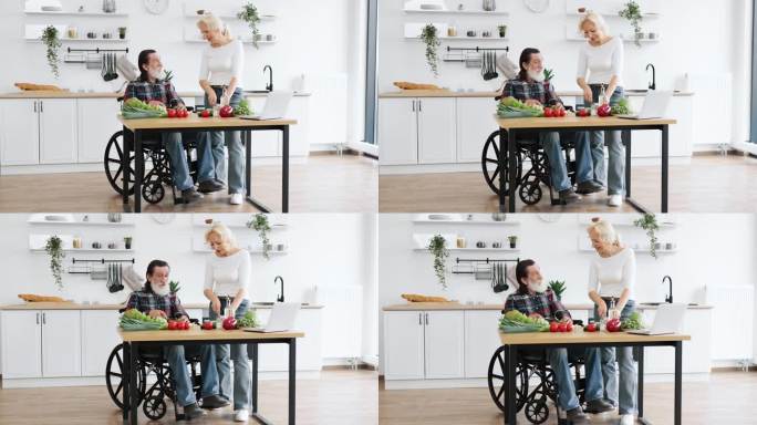 坐在轮椅上的快乐老男人和妻子准备了健康的沙拉。
