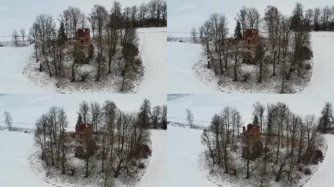 鸟瞰废弃的老教堂塔楼废墟，白雪皑皑的冬季景观
